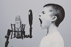 Boy singing into microphone